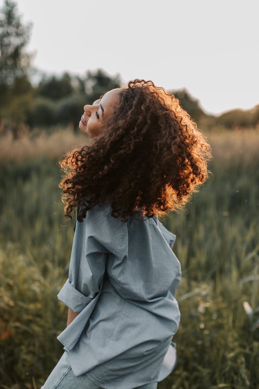 photo of woman wearing blue dress shirt